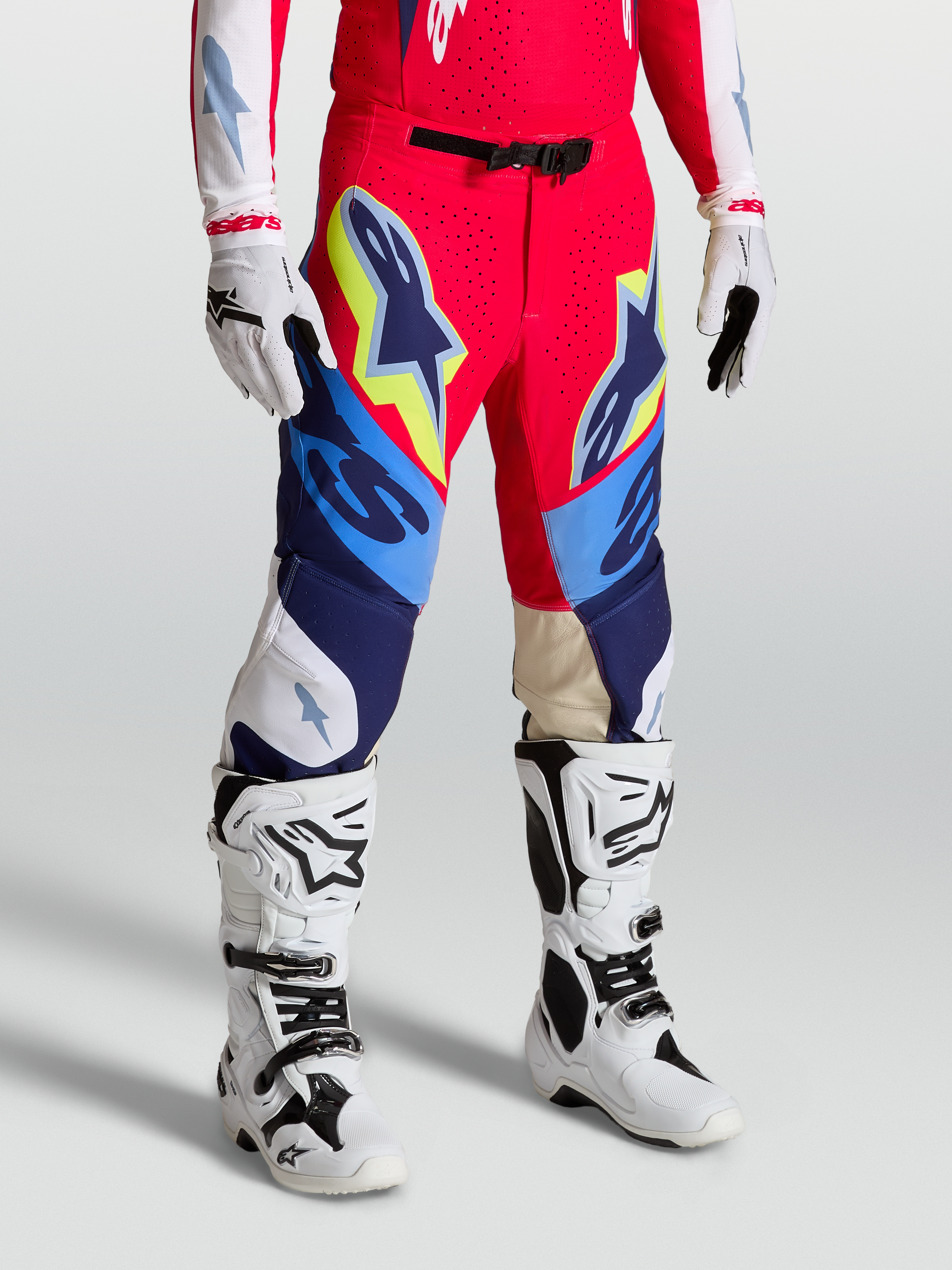 Alpinestars Supertech Dyna Pants, Motocross Racing Gear in Fire Red, White and Navy Blue with athletic fit and stretch panels.