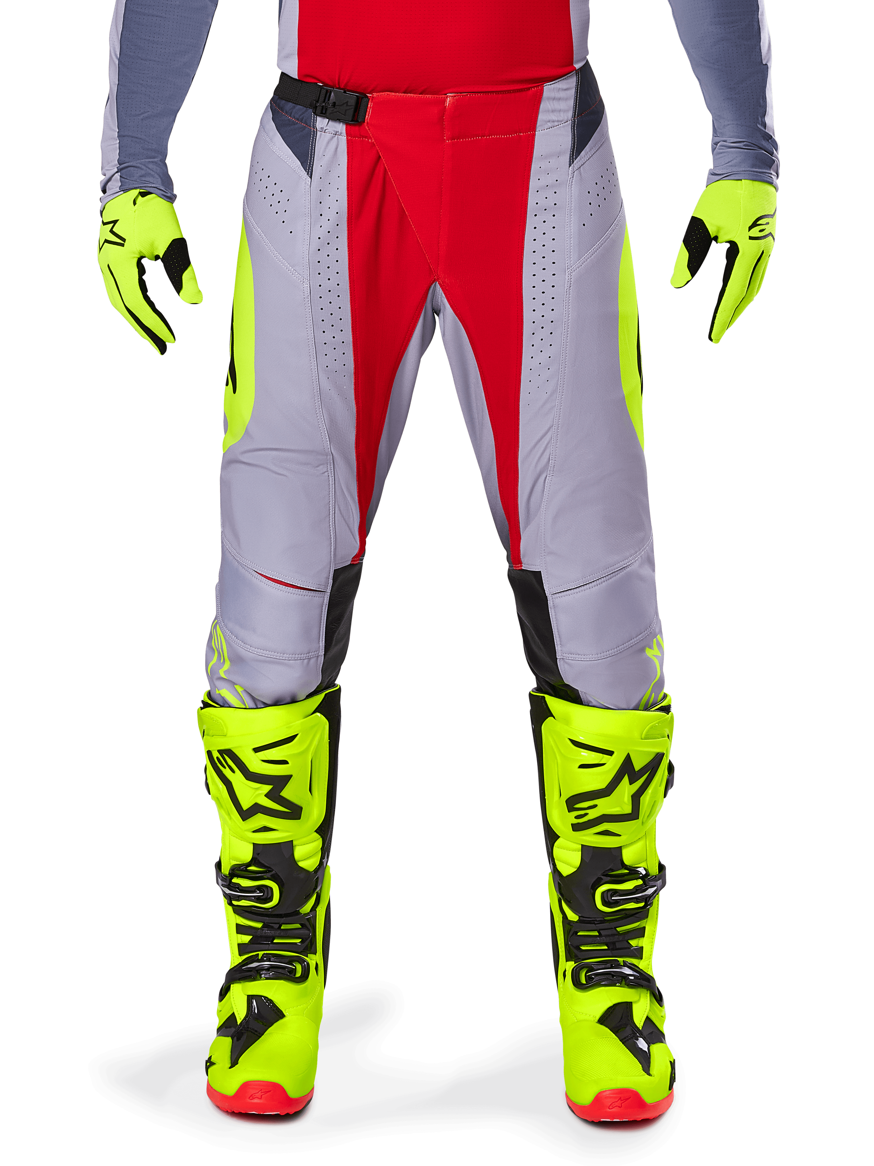 Alpinestars 2025 Techstar Melt Pants, Motocross Pants, Bright Red and Gray with fluorescent yellow accents, worn with matching neon yellow gloves and boots, featuring a magnetic waist buckle and laser-cut perforations for ventilation.