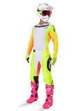 Alpinestars 2025 Techstar Melt Gear Set, complete motocross racing outfit, white jersey with yellow and orange sleeves, neon yellow pants, bright pink boots, white helmet with red goggles, yellow gloves, vibrant colorful racing apparel