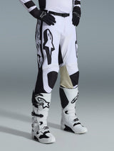 Alpinestars 2026 Racer Riway Pants, Motocross Pants, White and Black, featuring bold black Alpinestars graphics and logos, tan leather inner knee reinforcements, worn with white and black motocross boots and black gloves, professional racing gear for off-road riding.
