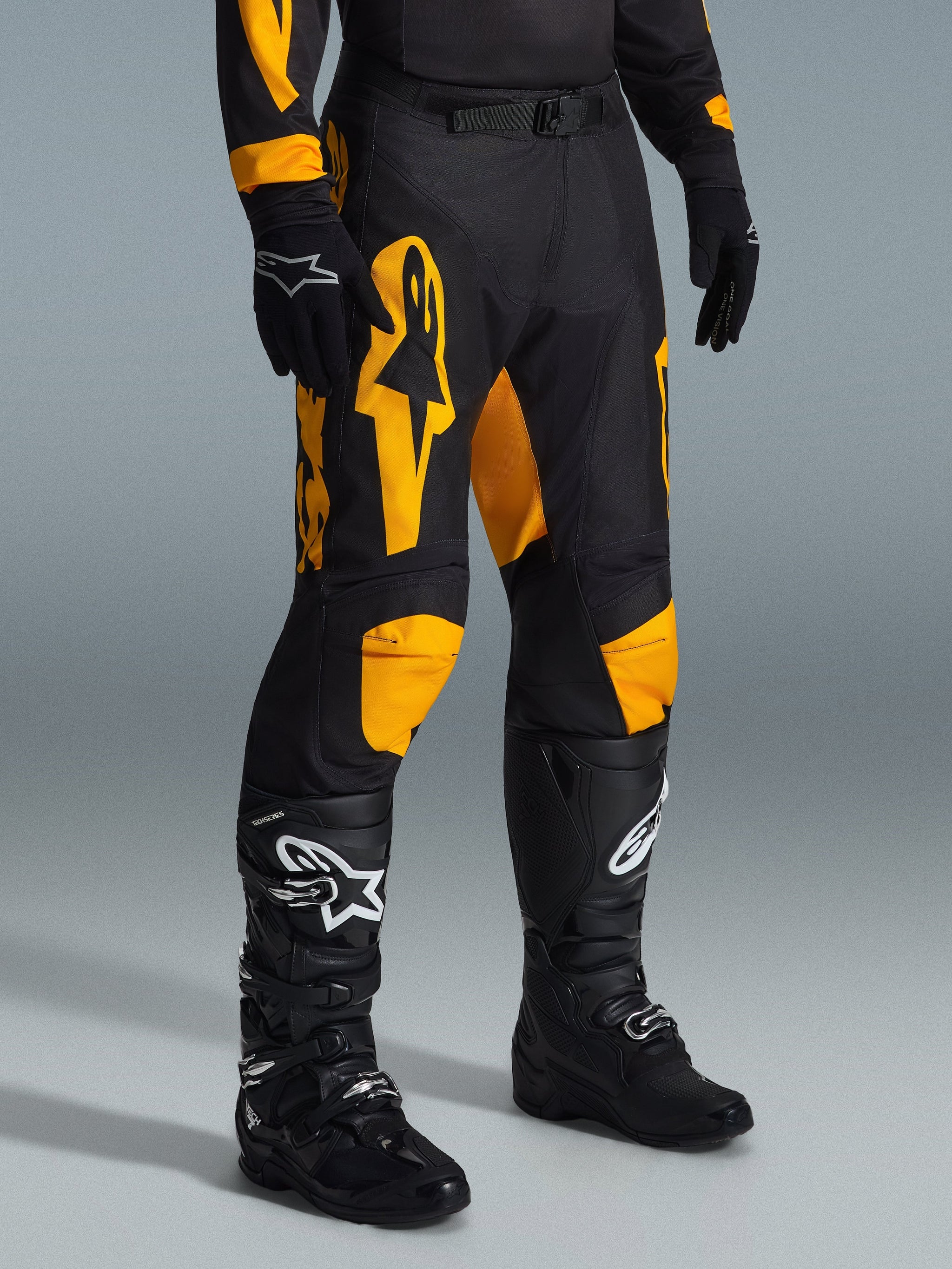 Alpinestars 2026 Racer Riway Pants, Motocross Pants, Yellow and Black, worn with black gloves and black motocross boots, featuring bold yellow Alpinestars branding and knee accents on a black chassis, designed for high-performance off-road racing