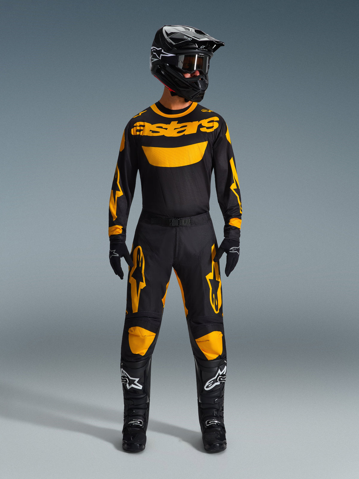 Alpinestars 2026 Racer Riway Gear Set, complete motocross racing outfit, black jersey with yellow astars branding, black pants with yellow knee and thigh accents, matching black helmet, goggles, gloves and boots, professional off-road apparel
