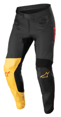 Alpinestars Supertech Blaze Pants, Motocross Pants, Black, Warm Yellow and Red Fluo, featuring a distinctive yellow knee panel, red star logo accents, secure ratchet waist closure, and reinforced protective panels for off-road performance.
