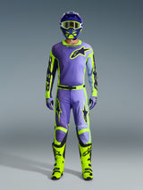 Alpinestars 2026 Racer Portl Pants and matching gear set, Motocross rider in Purple and Yellow Fluo, featuring a coordinated jersey, helmet, goggles, and bright yellow boots, designed for off-road performance.