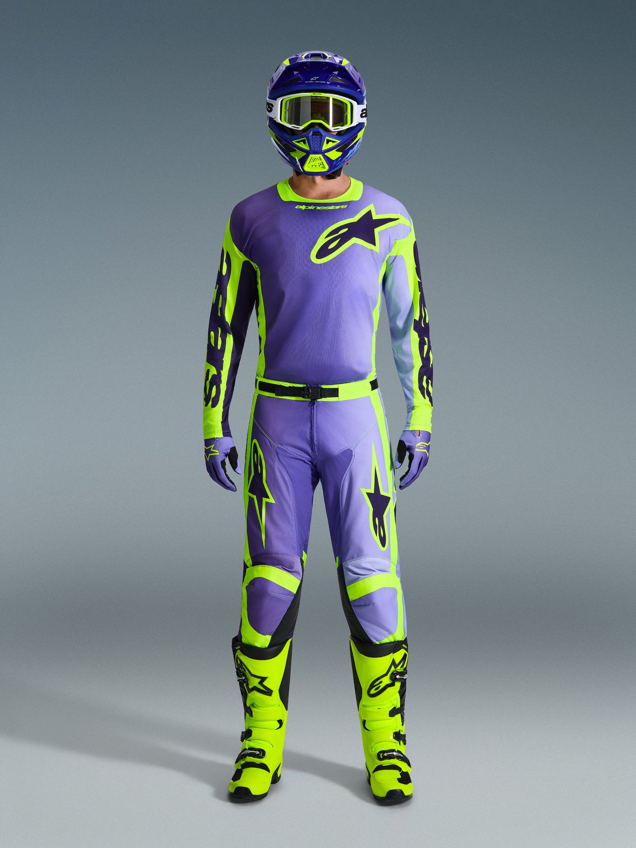 Alpinestars 2026 Racer Portl Pants and matching gear set, Motocross rider in Purple and Yellow Fluo, featuring a coordinated jersey, helmet, goggles, and bright yellow boots, designed for off-road performance.