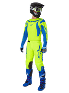 Alpinestars 2025 Fluid Haul Pants, Motocross Pants, Bright Yellow Fluo and Blue, worn as part of a complete racing gear set with matching jersey, blue boots, and a black helmet, high-visibility design for off-road riding.