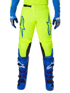 Alpinestars 2025 Fluid Haul Pants, Motocross Pants, Bright Yellow and Blue, worn with matching gloves and boots, featuring black inner knee panels, bold blue branding on the thighs, and a sporty ergonomic design.
