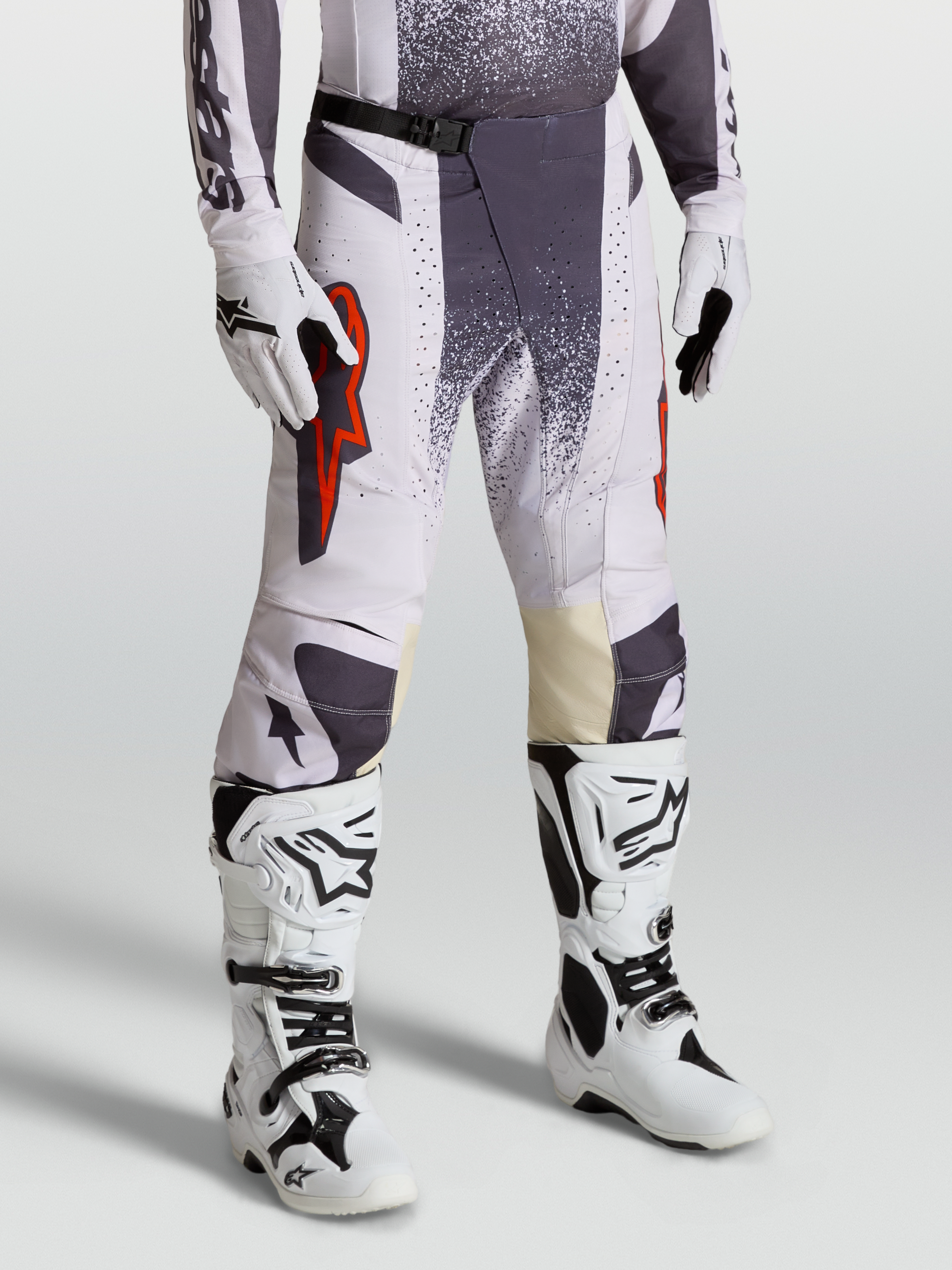 Alpinestars Techstar Swan Pants, Motocross Racing Pants for Men, Light Lilac and Dark Gray with Red Fluo accents, on-model shot with gloves and boots.