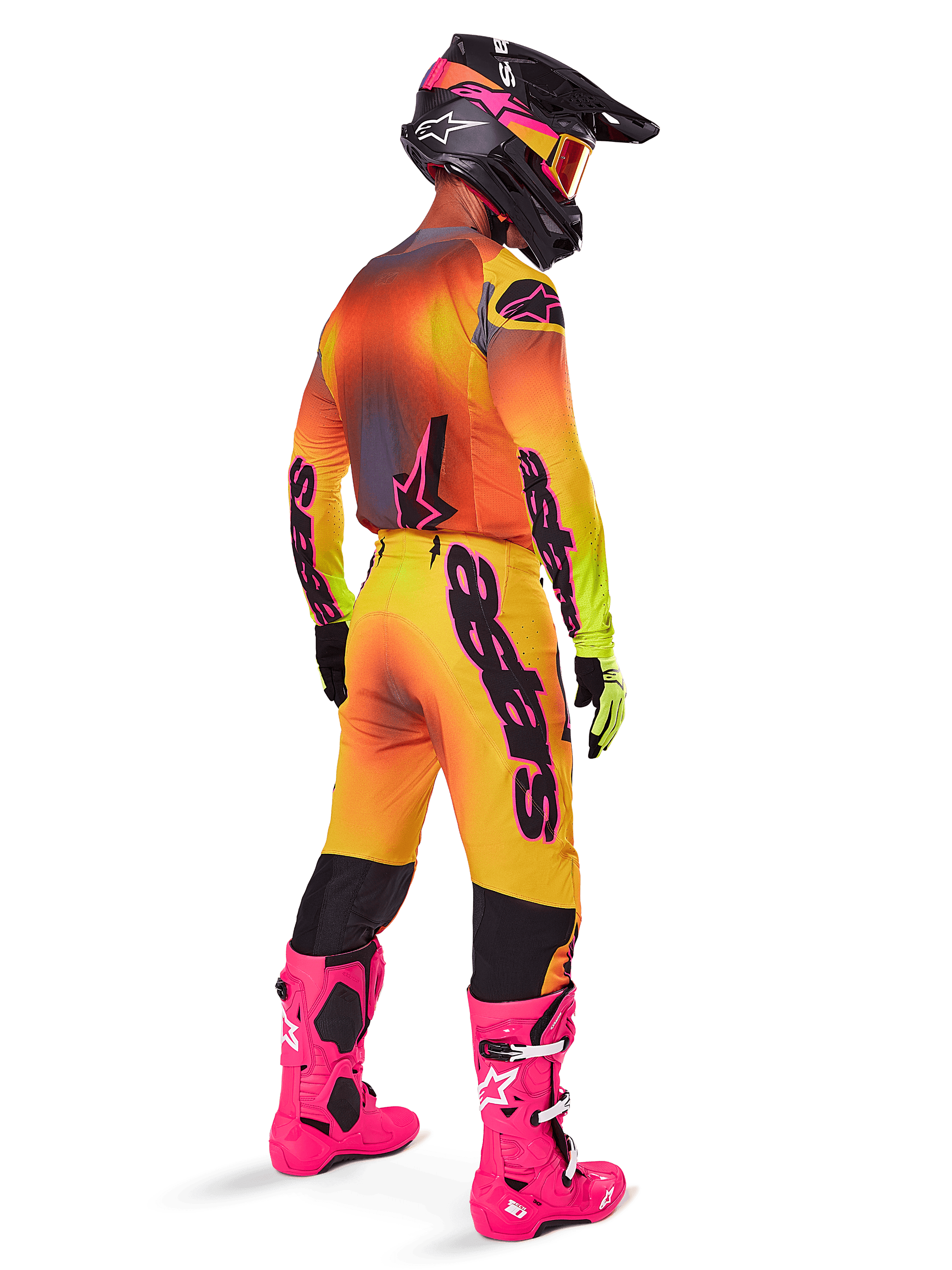 Motocross rider from a rear view wearing Alpinestars 2025 Supertech Lipan Pants, Yellow and Pink gradient, styled with matching jersey, bright pink boots, and a black helmet with pink accents, professional coordinated outfit for off-road racing.