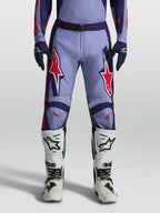 Alpinestars Racer Air Hunt Motocross Pants in light violet and deep purple with pink fluo accents, worn with white boots.