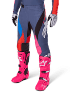 Alpinestars 2025 Techstar Dreem Pants, Motocross Pants, Dark Gray with Blue Red and Pink Panels, White Graphics, worn with bright pink boots and black and white gloves, bold high-visibility design