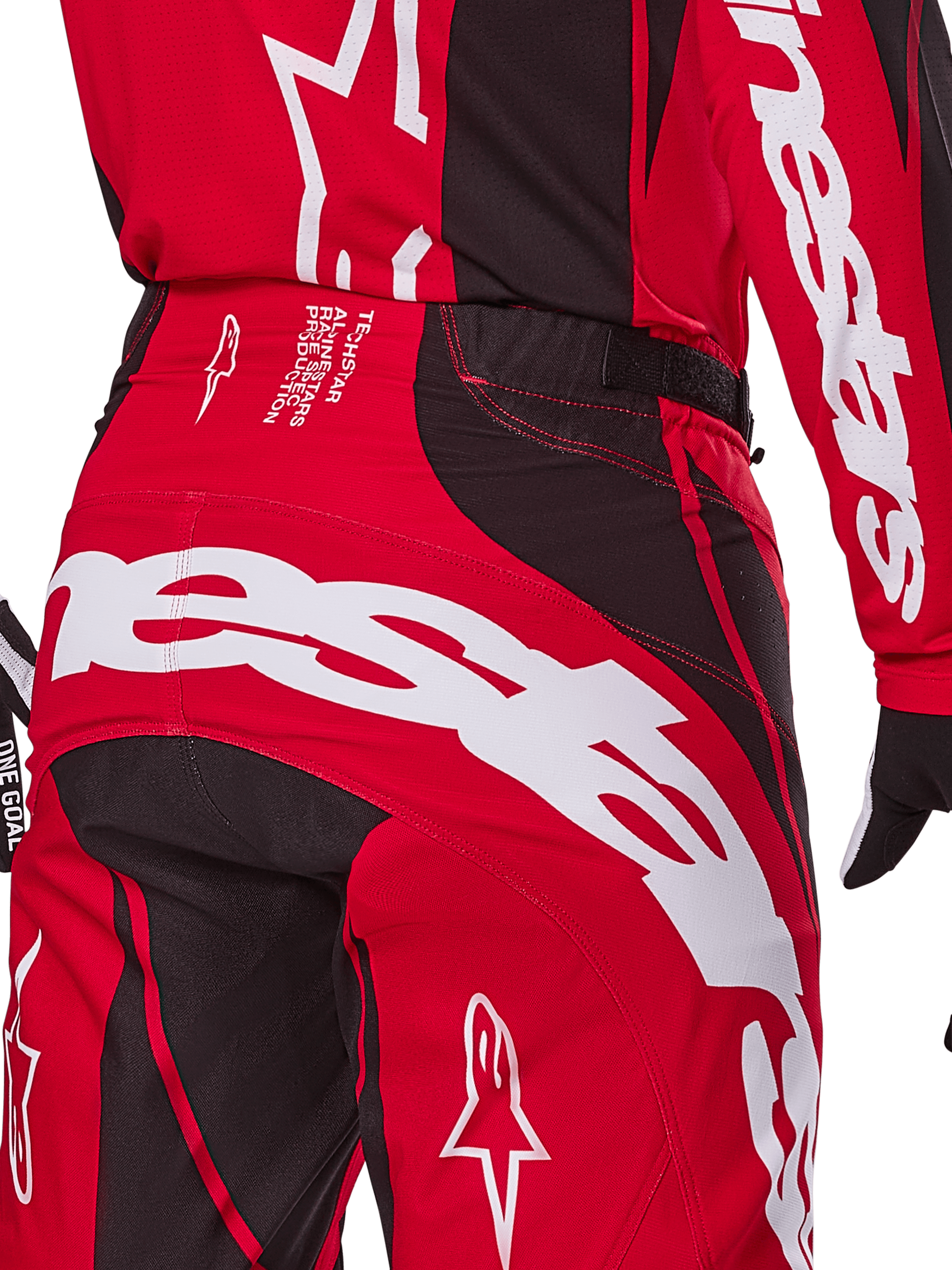Alpinestars 2025 Techstar Dreem Pants, Motocross Pants, Bright Red and Black, close-up of the rear waist and seat area featuring bold white Alpinestars branding, black stretch panels, and technical production text on the waistband, designed for off-road racing performance.