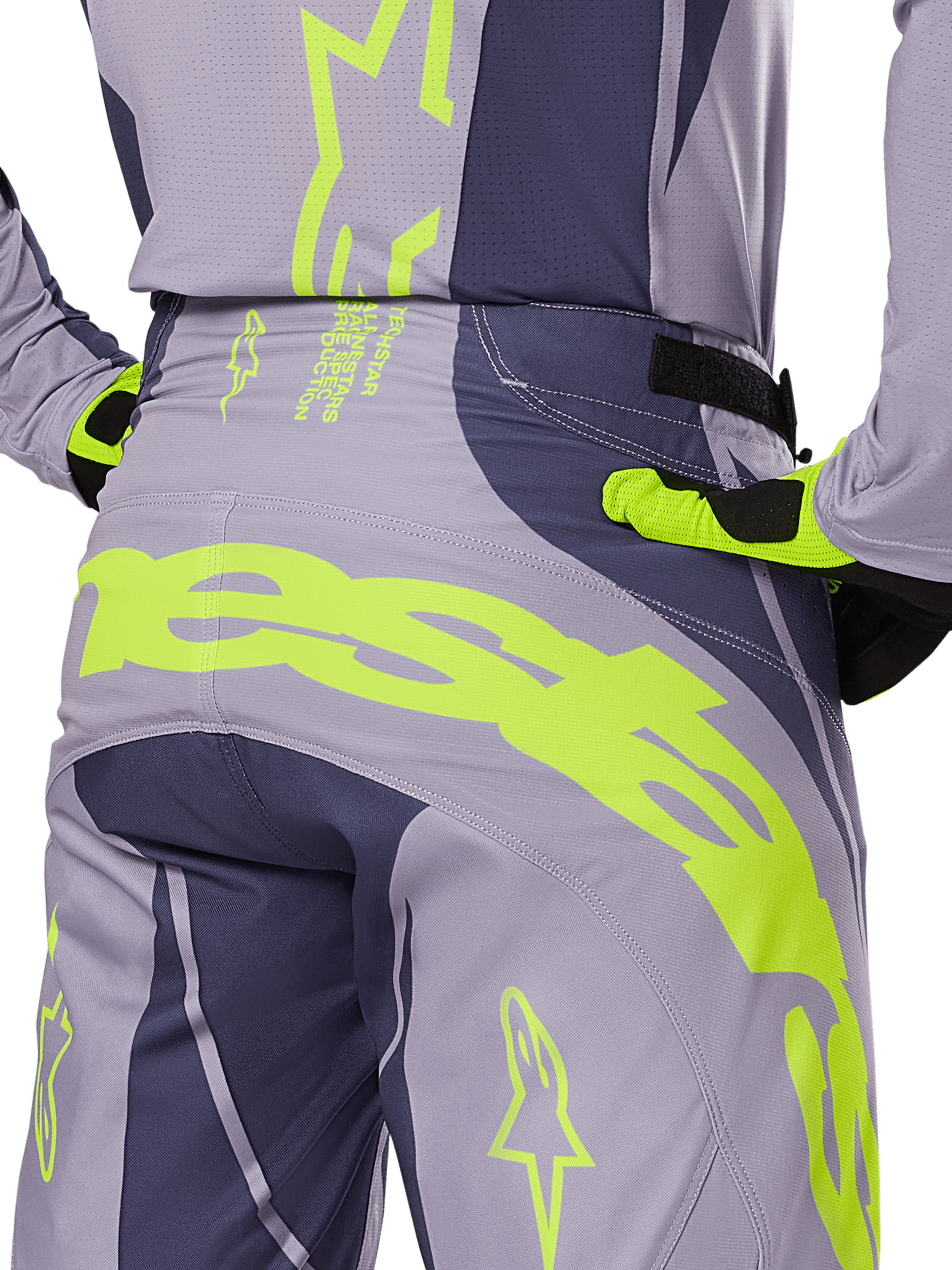 Alpinestars 2025 Techstar Dreem Pants, Motocross Pants, Gray and Dark Gray with fluorescent yellow accents, rear view showing bold Alpinestars branding across the yoke, worn with matching jersey and gloves, designed for off-road racing.