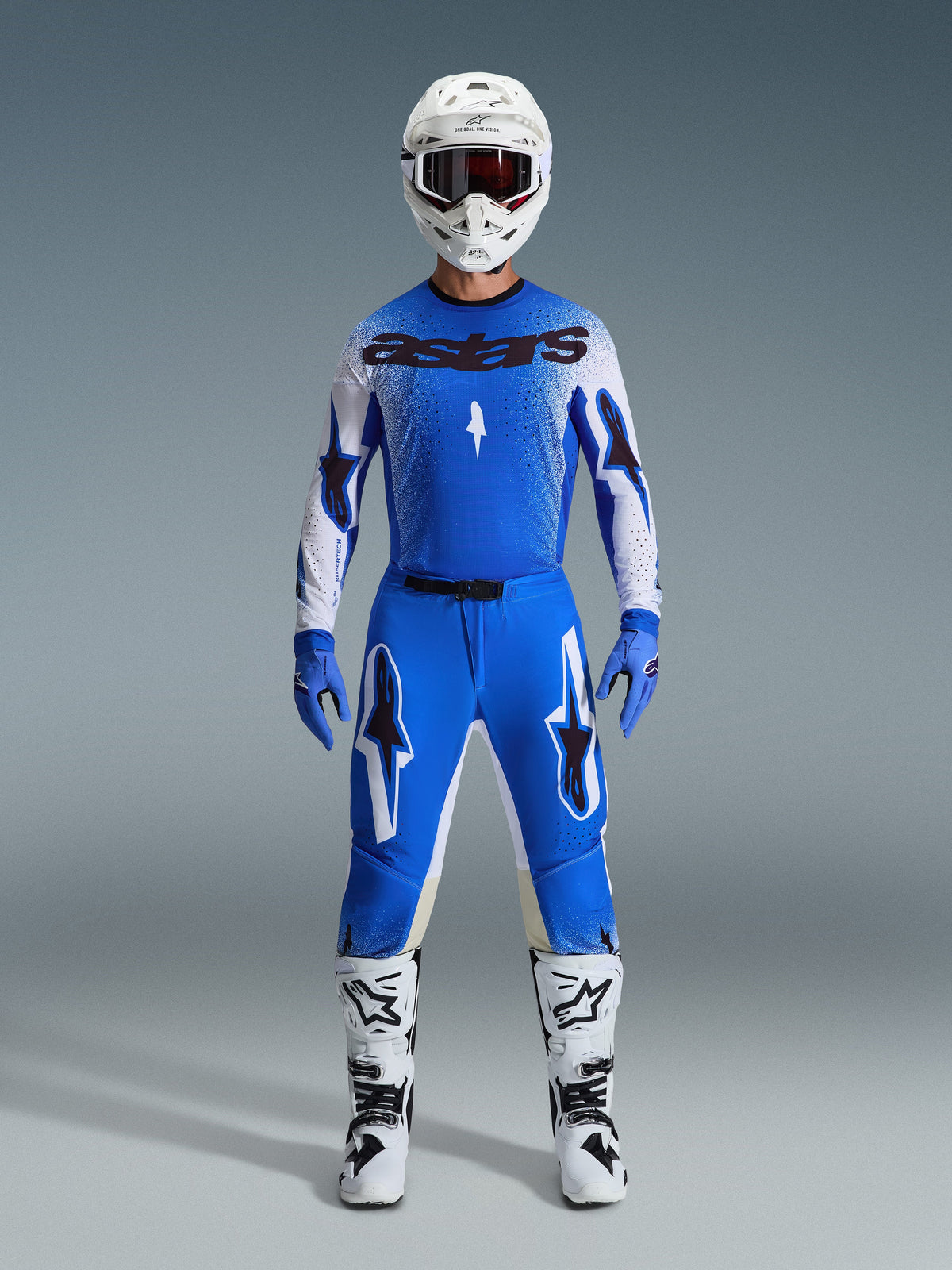 Alpinestars 2026 Supertech Scenz Gear Set, Motocross Racing Gear, Ucla Blue and White, complete racing outfit featuring a blue jersey with black 'astars' logo, matching pants with star graphics, white helmet with dark goggles, blue gloves, and white boots with black accents