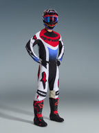 Alpinestars 2026 Techstar Knif Pants, Motocross Pants, Black White and Red, worn by a rider in full racing gear with matching jersey and boots, featuring bold red Alpinestars logos on white panels and a performance-oriented athletic fit.
