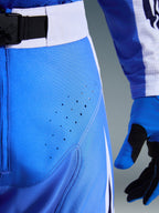 Alpinestars 2026 Techstar Knif Pants, Motocross Pants, Ucla Blue and Black, close-up view of thigh with laser-cut perforations and SX2 magnetic waist buckle, technical construction for off-road racing