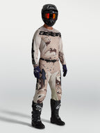 Alpinestars Racer Lone Gear Set, tan and brown camo motocross jersey and pants, with black boots for off-road performance.