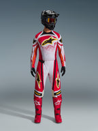 Alpinestars 2026 Techstar Nomur Gear Set, Motocross racing suit, Red white and black with yellow star logos, complete riding outfit featuring helmet, goggles, gloves, and boots, athletic race design for off-road performance