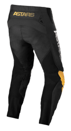 Alpinestars Techstar Quadro Pants, Motocross Pants, Black Yellow and Tangerine, rear view featuring yellow 'ASTARS' branding on the waistband, black mesh inserts for ventilation, and ergonomic yellow and tangerine knee panels for off-road racing durability.
