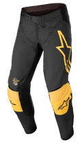 Alpinestars Techstar Quadro Pants, Motocross Off-Road Pants, Black and Yellow with Tangerine accents, featuring a large yellow star logo on the left thigh, reinforced yellow knee padding with black logos, ventilation holes, and a secure ratchet waist closure for a high-performance race fit.