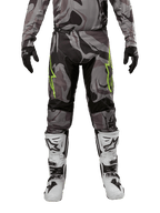 Alpinestars 2024 Racer Tactical Pants, Motocross Pants, Cast Gray Camo Magnet, worn with matching camo jersey, black gloves, and white and black boots, featuring lime green star logos on the thighs and black stretch panels, front view for off-road riding gear