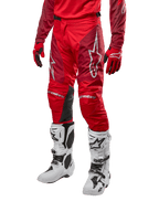 Alpinestars 2024 Racer Hoen Pants, Motocross Pants, Mars Red and Burgundy, worn with matching red jersey and gloves and white boots, featuring black leather knee panels and white logos, durable technical gear for off-road racing