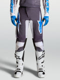 Alpinestars Fluid Drag Pants for motocross, Graystone and Ucla Blue, with pre-curved legs and ergonomic polyfabric protection.
