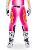 Alpinestars Limited Edition Supertech AFD MIG Pants, Motocross Racing Pants, Pink Fluo and White with Orange accents, featuring large star logos on the thighs, perforated panels, and black knee grip zones, worn with white and black motocross boots