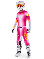 Motocross rider wearing the Alpinestars Supertech AFD MIG Limited Edition Gear Set, Pink Fluo White and orange gradient jersey and pants, white helmet with orange goggles, white and black boots, professional dirt riding apparel