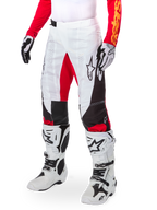 Alpinestars Limited Edition Techstar Deep Pants, Motocross Pants, White Black and High Red, worn with white and black boots and gloves, featuring white front panels with red accents and black side detailing, designed for high-performance off-road racing