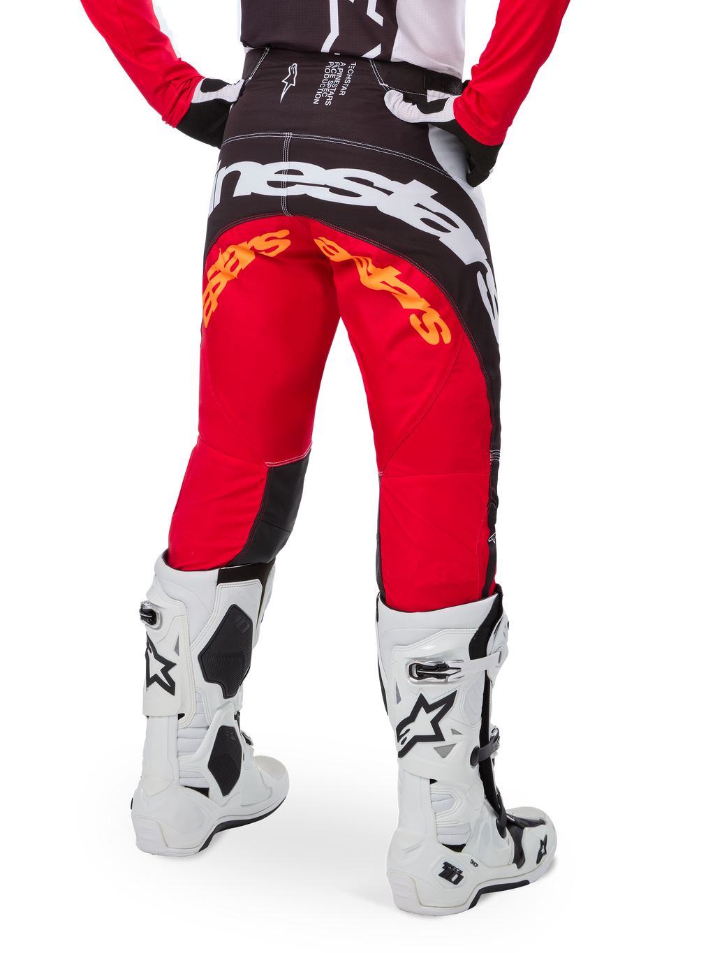 Alpinestars Limited Edition Techstar Deep Pants, Motocross Pants, Black White and High Red, rear view featuring bold white Alpinestars logo across the seat and orange branding, worn with white technical boots for professional off-road racing.