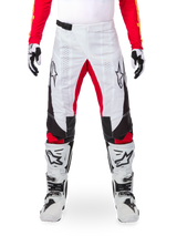 Alpinestars Limited Edition Techstar Deep Pants, Motocross Pants, Black White and High Red, worn with matching red jersey, white and black gloves and boots, featuring white front panels, red inner leg accents, black side panels, Alpinestars logos on thighs, and laser-perforated details for ventilation.