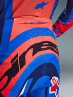 Alpinestars 2026 Supertech Vista Pants, Motocross Pants, Dark Navy Hot Coral and Cobalt, close-up rear view showing bold branding, laser-cut perforations for ventilation, and 'SUPERTECH' logo on the waistband, performance stretch material for off-road racing