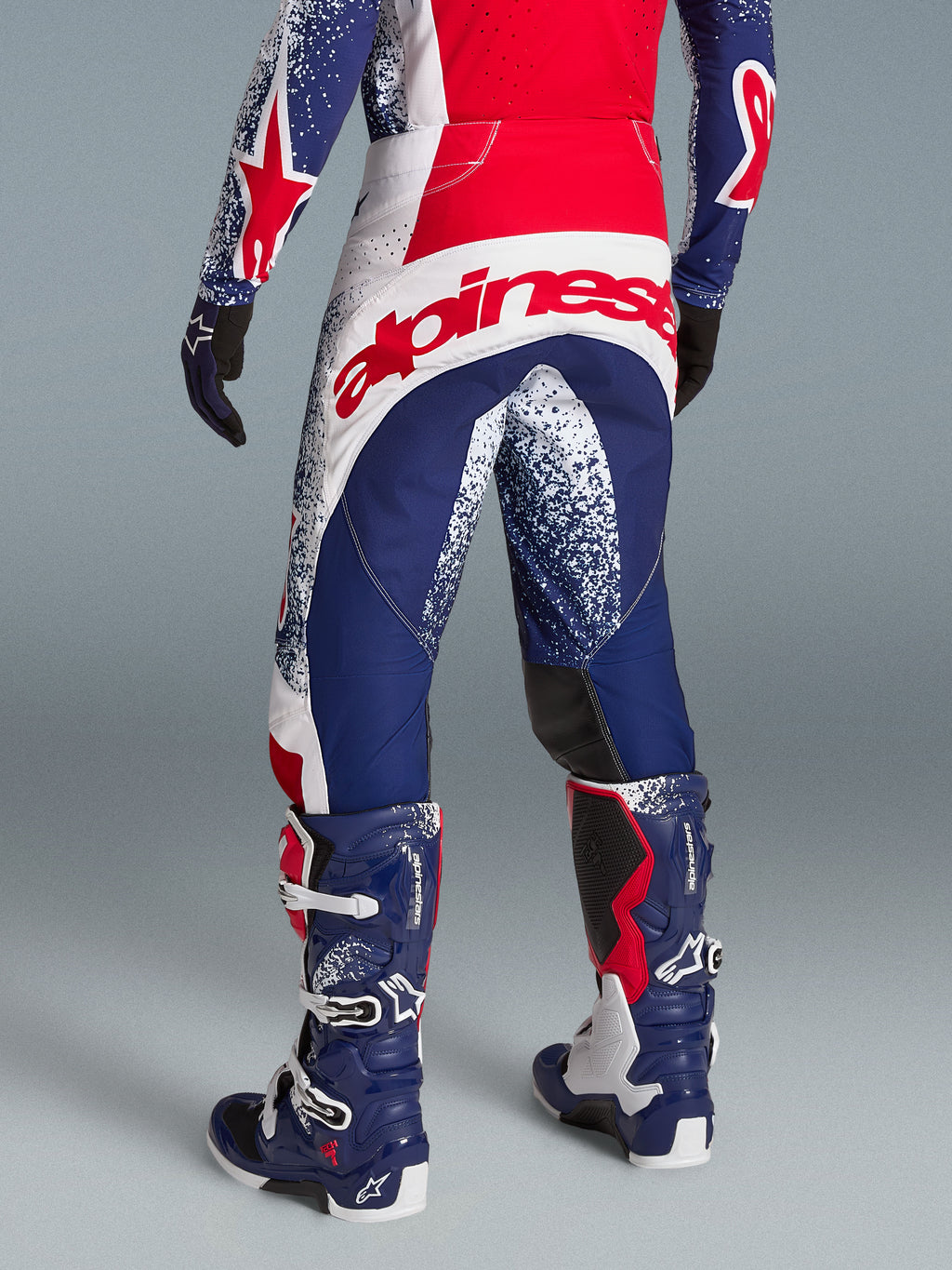 Alpinestars Limited Edition Techstar Unity Pants, Red, White, and Blue Motocross racing gear with a large rear logo on-model.