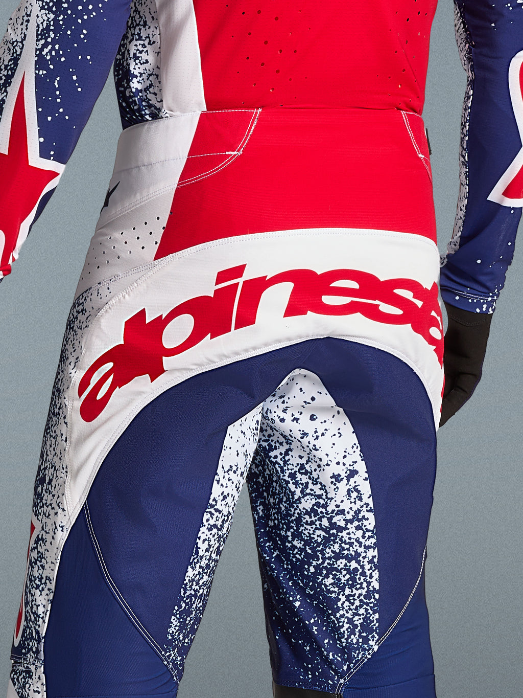 Alpinestars Limited Edition Techstar Unity Pants, Men's Motocross Racing, Red, White, and Blue, featuring a bold rear logo.