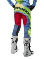 Alpinestars 2024 Techstar Ocuri Pants, Motocross Pants, Light Blue Yellow Fluo and Red Berry, back view worn with white and black motocross boots, featuring vibrant color-blocking and bold Alpinestars branding on the seat.