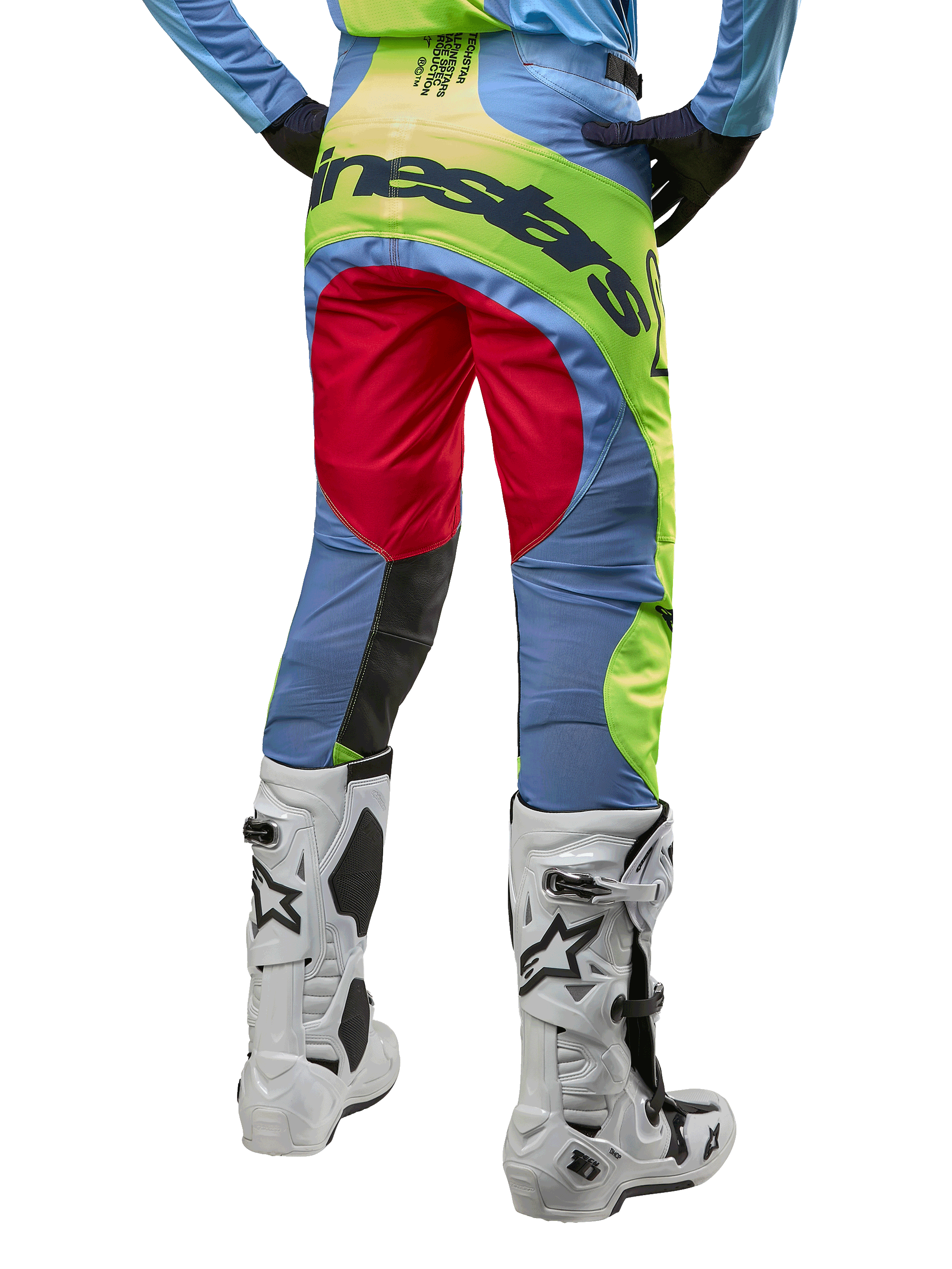 Alpinestars 2024 Techstar Ocuri Pants, Motocross Pants, Light Blue Yellow Fluo and Red Berry, back view worn with white and black motocross boots, featuring vibrant color-blocking and bold Alpinestars branding on the seat.