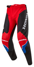 Alpinestars Honda Racer Iconic Pants, Motocross Pants, Bright Red Black and White with Blue accents, featuring a large white HONDA logo on the thigh, Alpinestars branding on the knees, ergonomic pre-curved leg construction, and adjustable ratchet waist closure.
