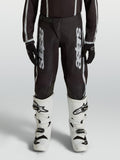 Alpinestars Youth Fluid Apex V2 Motocross Pants, Black and Silver, durable 600D polyfabric with ergonomic pre-curved legs.