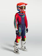 Alpinestars Youth Fluid Drag Pants in blue navy and red, worn as part of a complete motocross racing outfit.