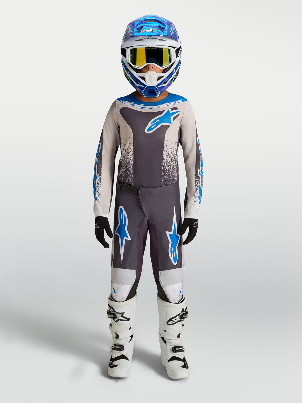Alpinestars Youth Fluid Drag Pants, Gray and Blue Youth Motocross Gear with durable polyfabric and white boots.
