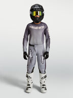 Alpinestars Youth Fluid Amber Pants, Gray and Sand 600D textile motocross pants for youth, shown with matching gear.