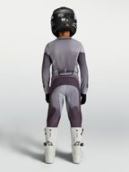Alpinestars Youth Fluid Amber Pants in sand and gray, durable youth motocross pants shown from behind on a rider.