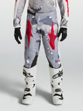 Alpinestars Youth Fluid Lone Pants in gray camo and fire red for motocross, featuring durable polyfabric construction.
