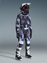Alpinestars 2026 Youth Fluid Lahnd Pants, Motocross Pants, Iron Camo, complete youth racing outfit with matching jersey, black helmet, and white and black boots, high-performance off-road gear for young riders