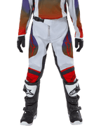 Alpinestars Youth 2024 Racer Hoen Pants, Motocross Pants, Light Gray Hot Orange Black, worn with matching jersey and black and white motocross boots, featuring red Alpinestars logos on thighs and knees, sporty design for off-road racing
