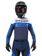 Alpinestars Pro-Dura Jersey, Motocross and Enduro Jersey, Navy, Bright Blue, and White, worn with matching navy pants, black gloves and helmet, featuring chest branding and laser-cut ventilation for off-road motorcycle racing