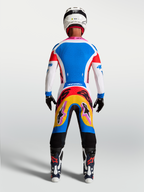 Alpinestars Supertech Dyna Jersey and Gear Set, blue and white motocross kit, rear view on-model with pink accents.