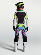 Alpinestars 2027 Supertech Dyna Jersey and Gear Set, men's pro motocross racing outfit in fluo green and black, rear view showing athletic fit and stretch mesh construction.