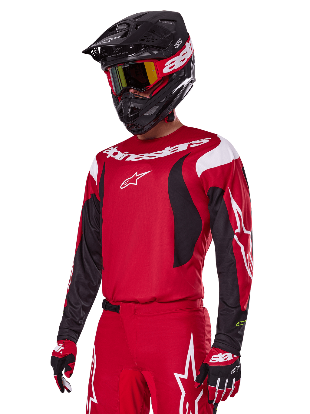 Motocross rider wearing Alpinestars 2025 Fluid Haul Gear Set in Red, featuring a red jersey with white and black accents, matching red pants with white graphics, black helmet with white branding, red and yellow goggles, and red and black gloves, coordinated motocross racing outfit